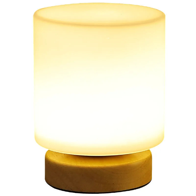 Nordic white geometric table lamp with solid wood base and USB charging port on a wooden desk.