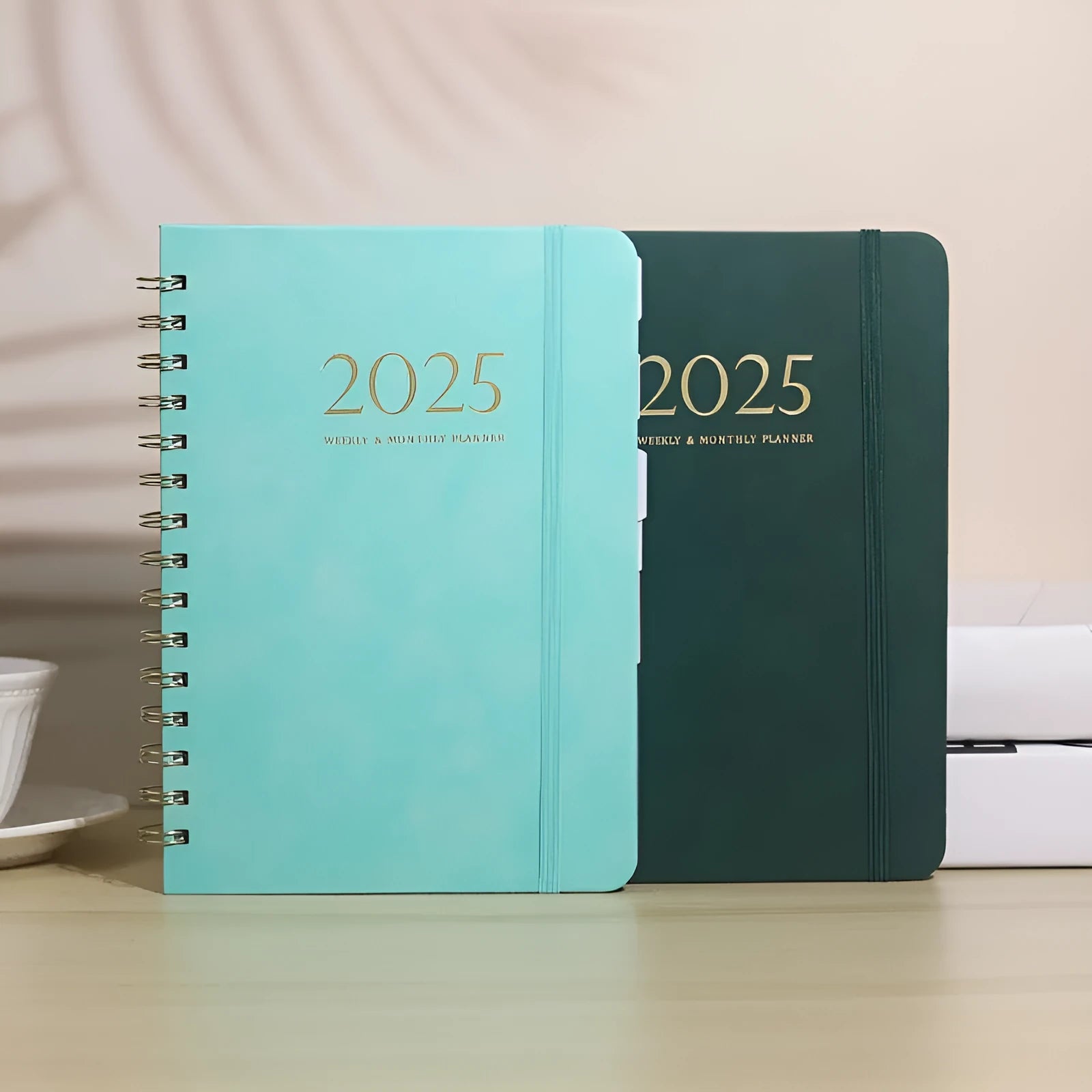 A5 leather notebook with metal coil binding in various colours including black, blue, and green.