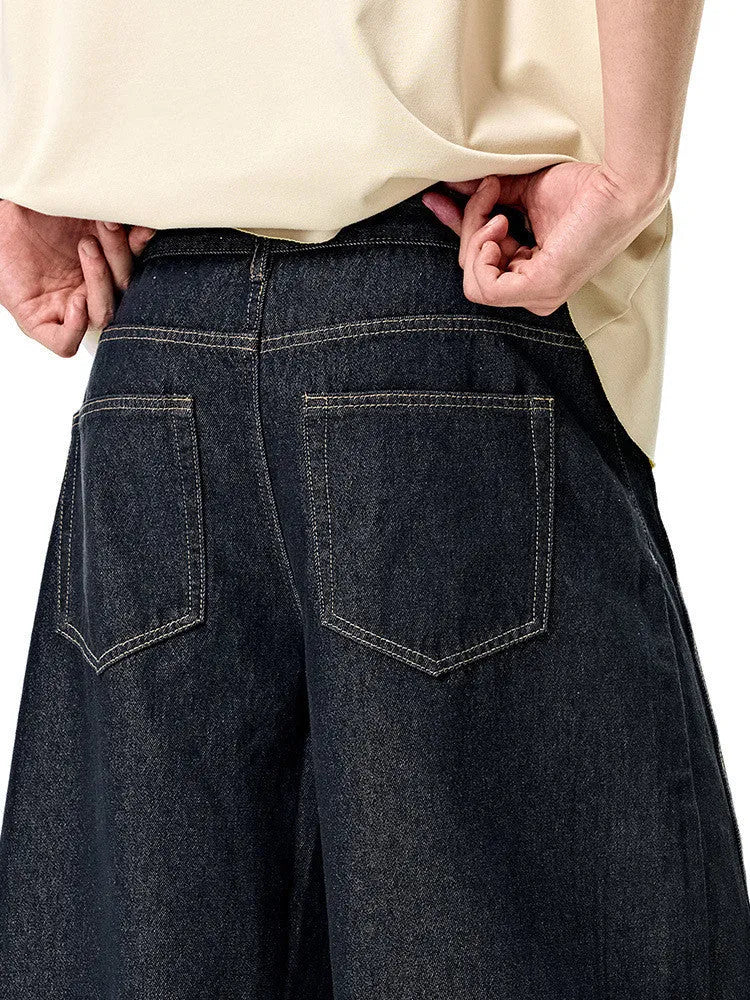 Men's original cow colour wide leg denim trousers laid flat, showing mid waist and straight leg cut.