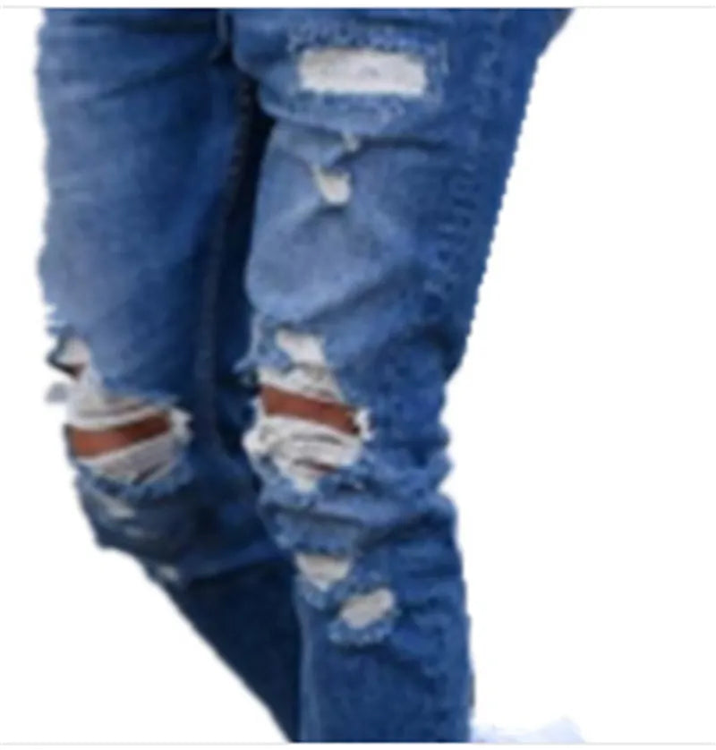 Men's deep blue cotton jeans with a distressed hole design laid flat.