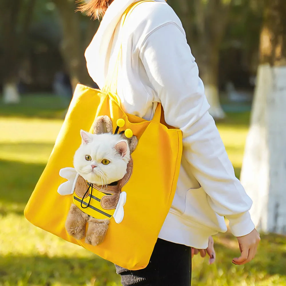 Canvas pet carrier shoulder backpack with cartoon pattern for small dog or cat transport.
