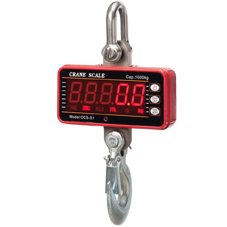 Orange electronic crane scale with digital display, showing a weight readout, hooked to a chain for lifting.
