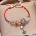 Women's hand-woven bracelet with a silver peace buckle charm and crystal sequin details on a blue band.