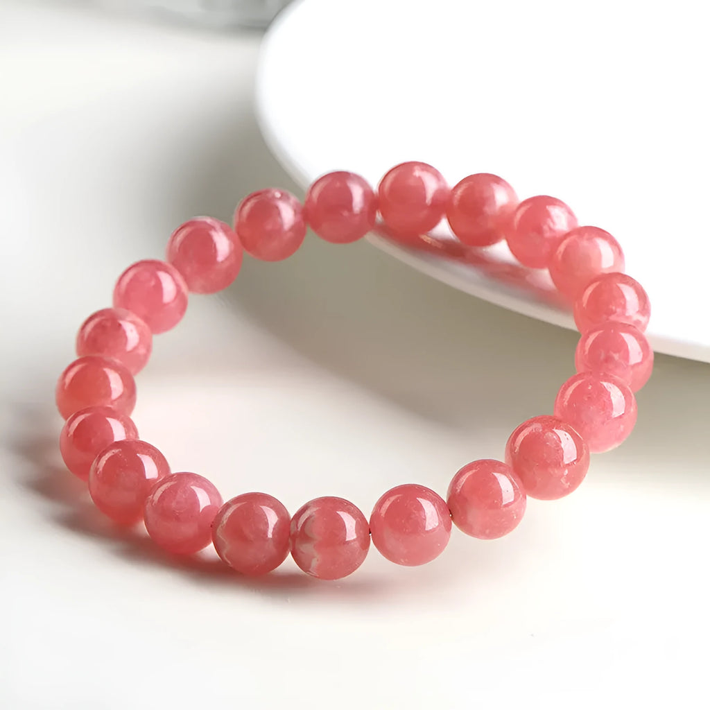 Women's geometric crystal bracelet with a longevity lock clasp in natural red rhodochrosite stone.