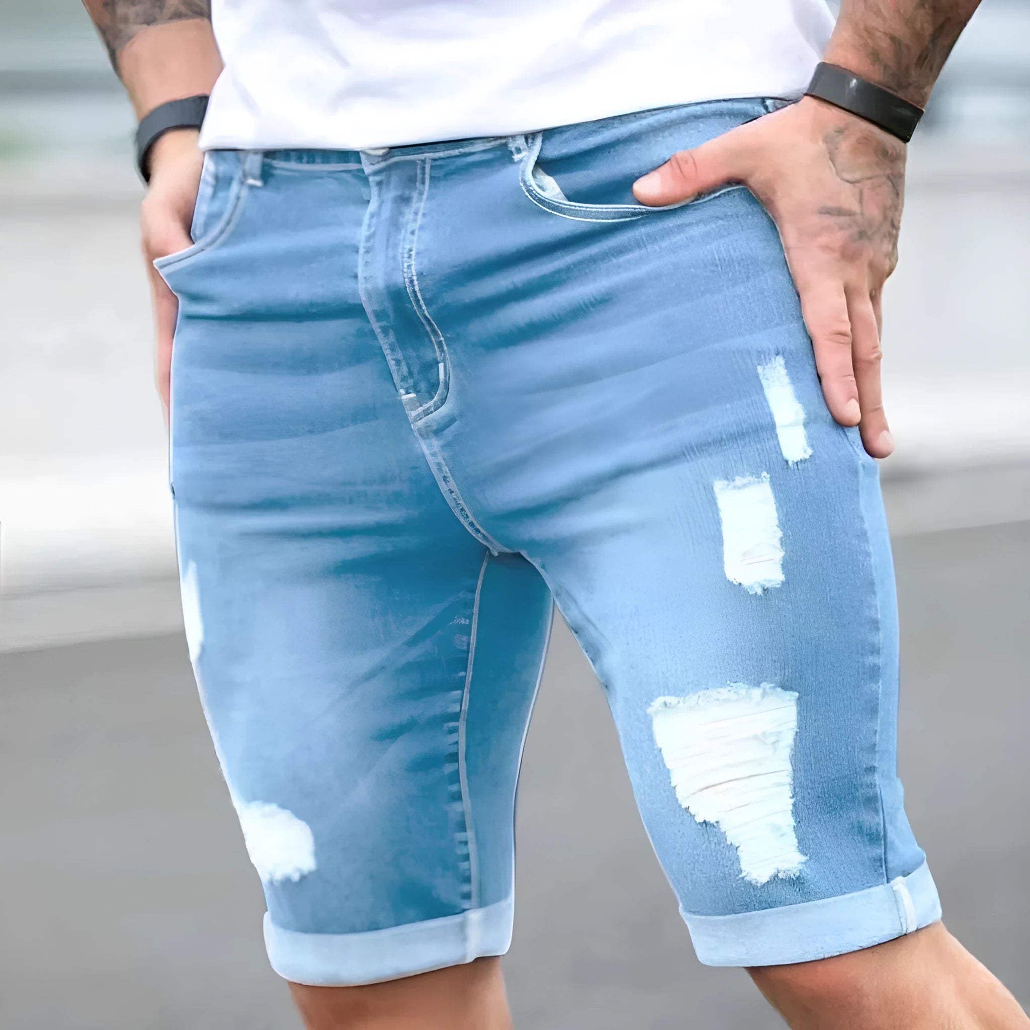 Sky blue men's denim shorts with distressed multi-hole detailing and low waist design