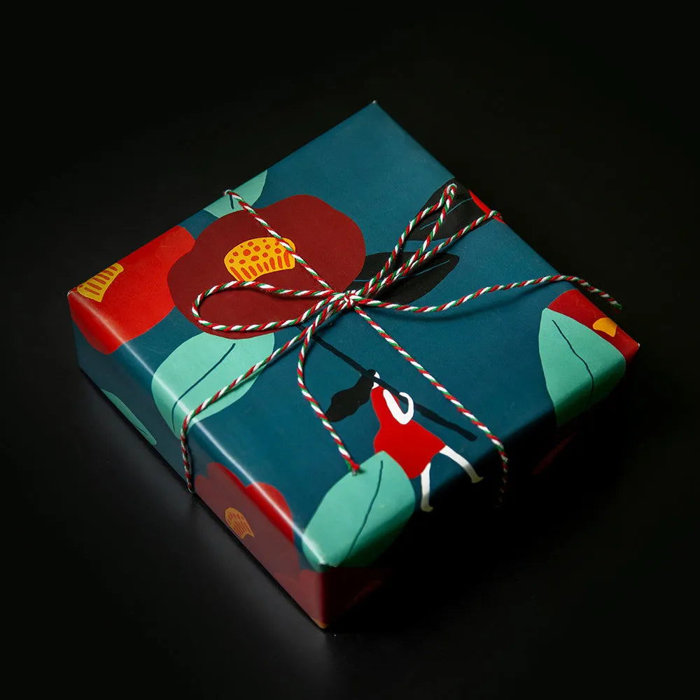 Green waterproof gift wrapping paper with camellia leaflet and black ribbon for gift box