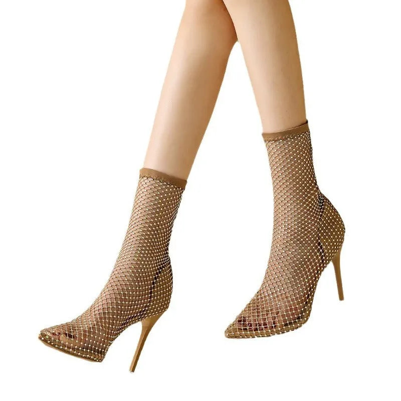 Gold mesh high heel sandals with a pointed toe and stiletto heel on a rubber sole.