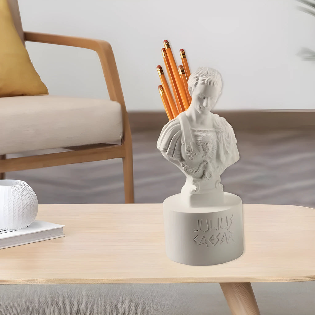 White synthetic resin pen holder with American cartoon character modelling on a desk.