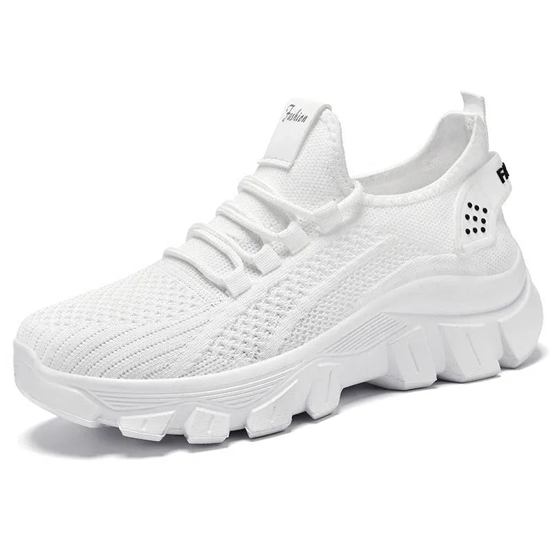 Women's white Flyknit running sneakers with thick PVC sole and lace-up front.