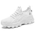 Women's white Flyknit running sneakers with thick PVC sole and lace-up front.