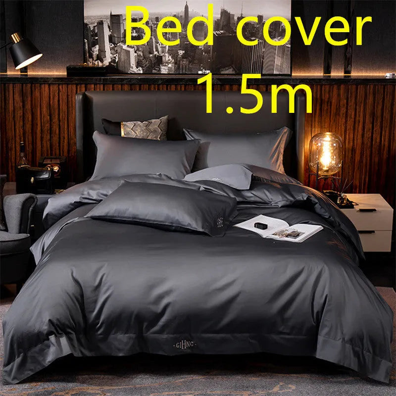 Four-piece cotton satin quilted bedding set with duvet cover, sheet, and pillowcases in a bedroom setting
