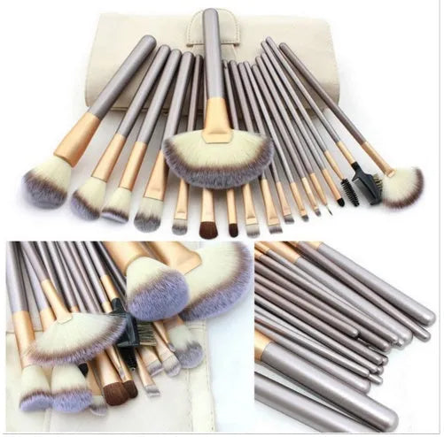 Persian makeup brush set with rice white bristles and champagne coloured handles laid out in rows.