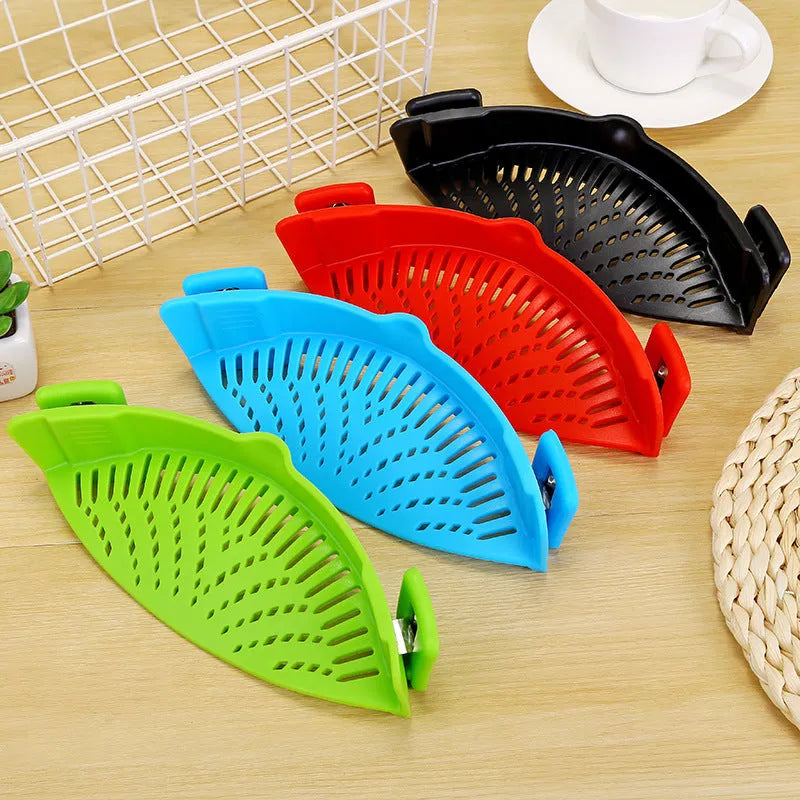 Silicone clip-on kitchen strainer with stainless steel filter mesh attached to a pot rim