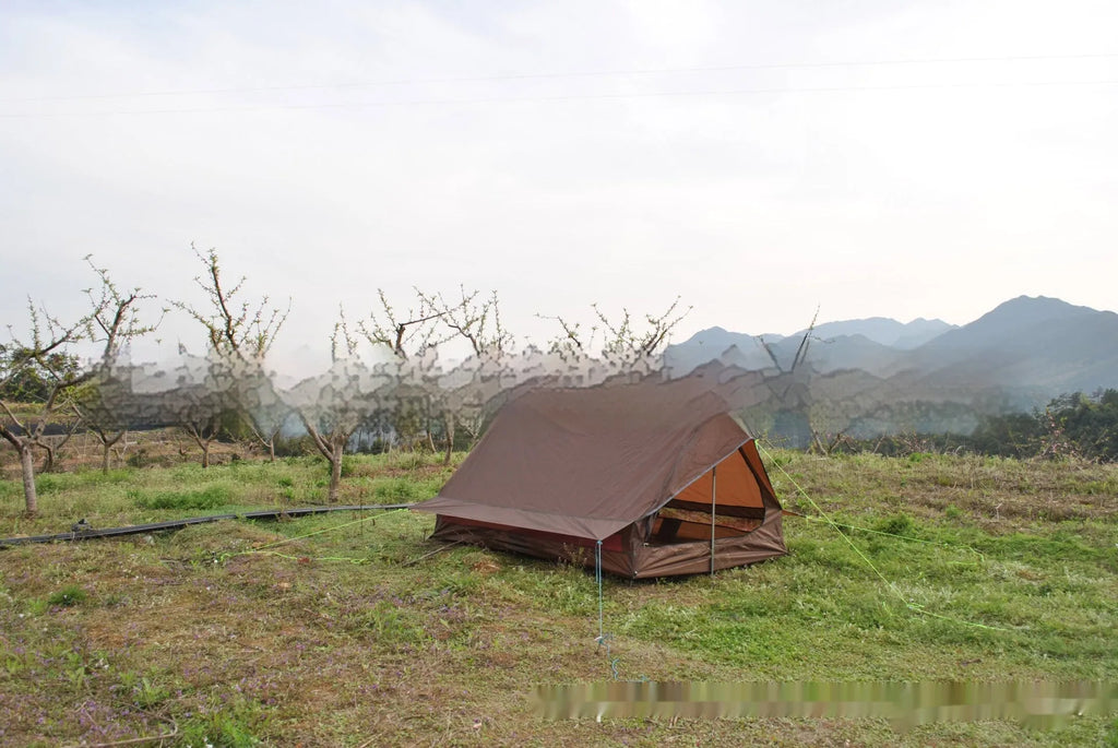Brown A-line tent pitched with hiking poles, showing guy lines and aluminium ground nails.