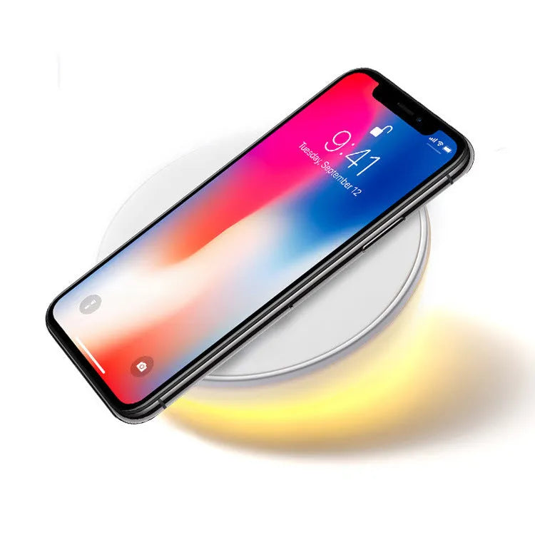 White wireless phone charger with clock display and control buttons on front