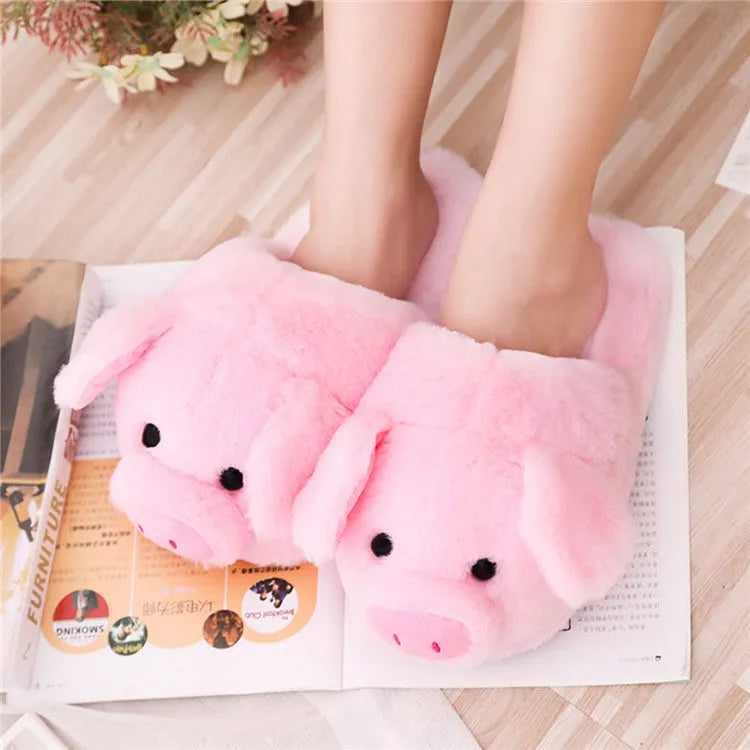 Pink pig-themed plush floor slippers for adults on a plain background.