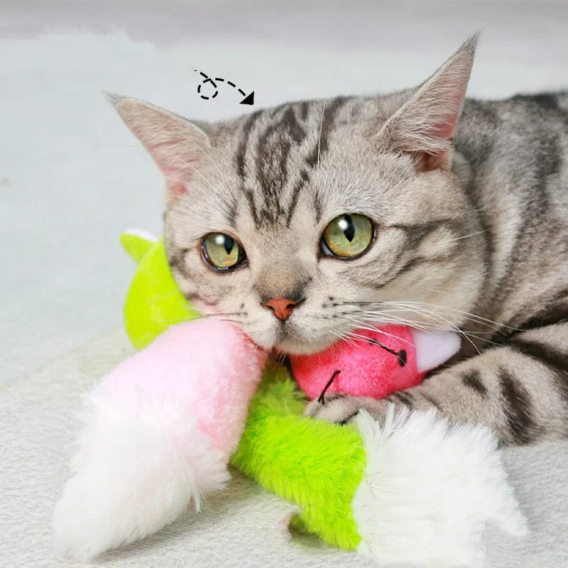 Three plush toy mice in green, pink, and blue with long tails, arranged on a surface
