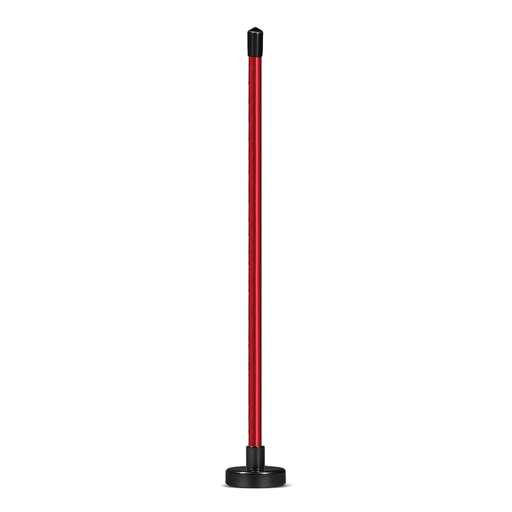 Red aluminium alloy magnetic golf alignment trainer bar on a putting green.