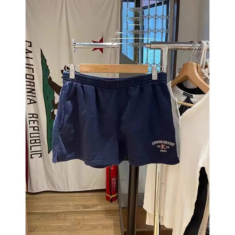 Women's dark blue cotton sports shorts with white flag embroidery detail