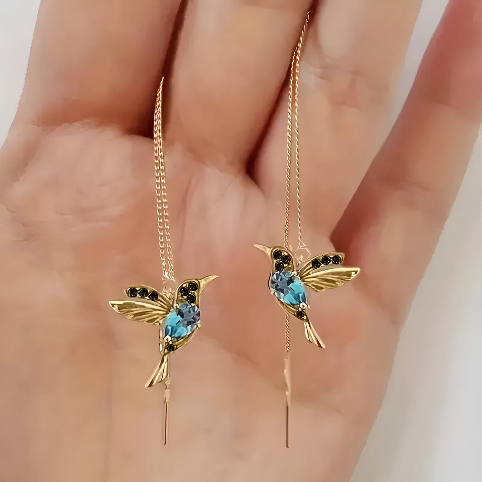 Women's long bird hanging earrings in alloy with blue electroplated finish.