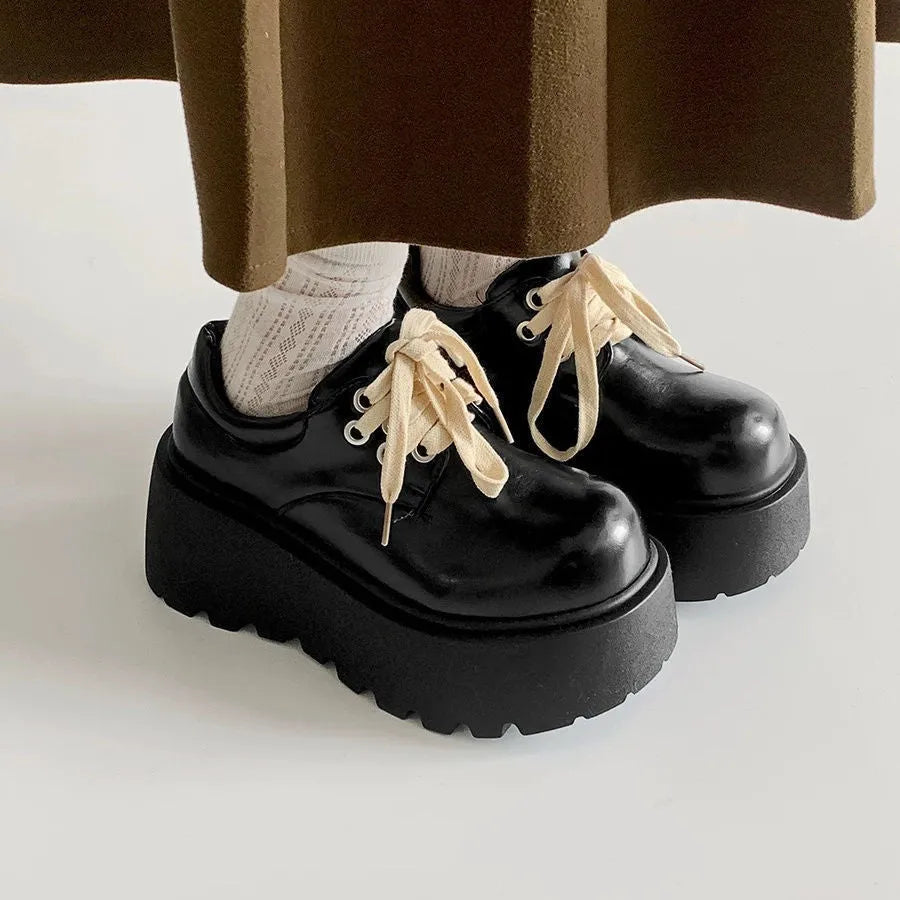 Matte black women's lace-up shoes with a chunky rubber sole and 6-8cm heel.
