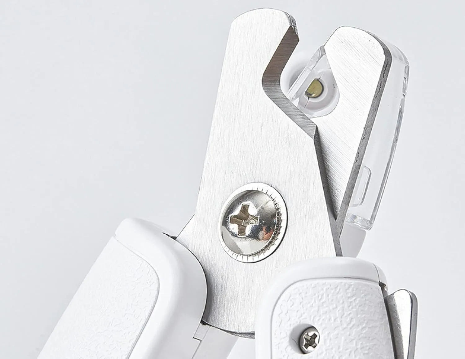 White pet nail clippers with LED light, transparent guard, triangular blades, and anti-slip handles for cat and dog grooming