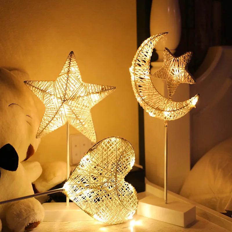 Rattan woven star-shaped LED table lamp with copper wire details on a table.