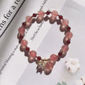 Handcrafted strawberry quartz crystal bracelet with Hetian jade peach blossom charms