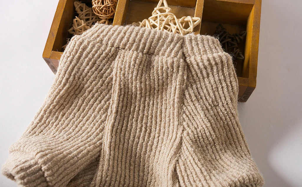 A brown cloth pullover sweater for a small dog on a white background.