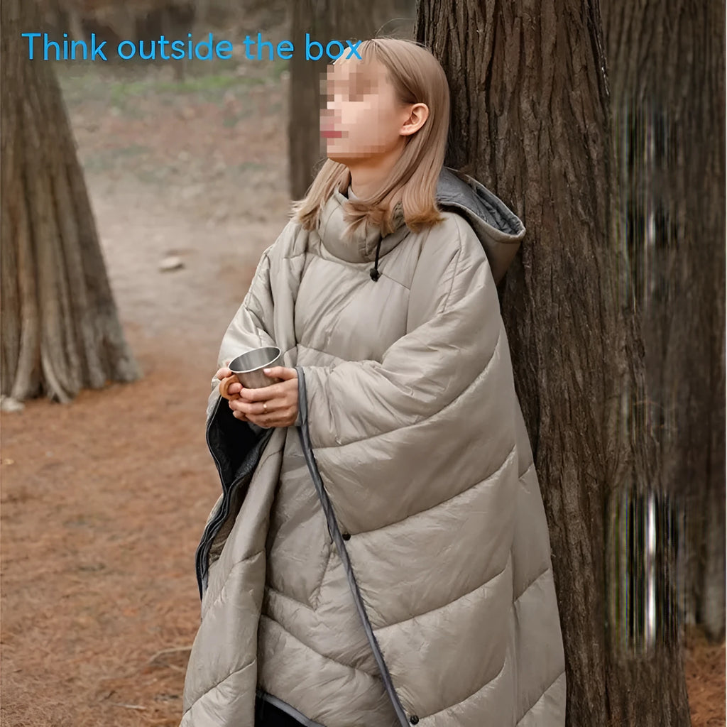 Outdoor cloak sleeping bag in grey laid out flat showing its 200x140cm rectangular shape.