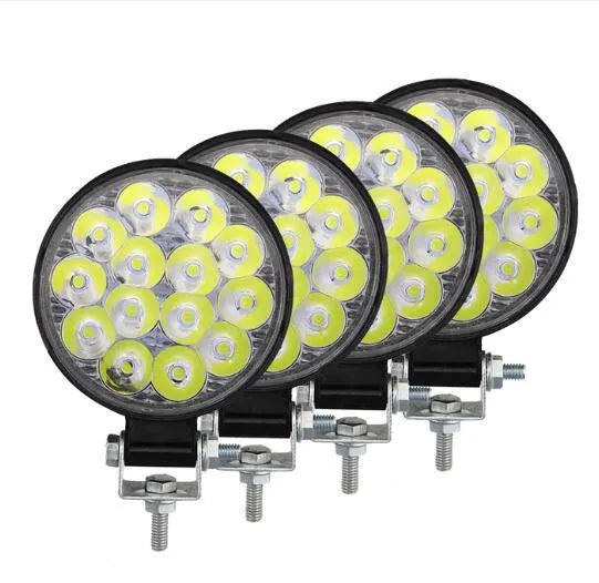 White aluminium LED work light with a round design, suitable for mounting on a vehicle.