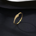 S925 silver bow ring with single row of diamond stones on a plain background