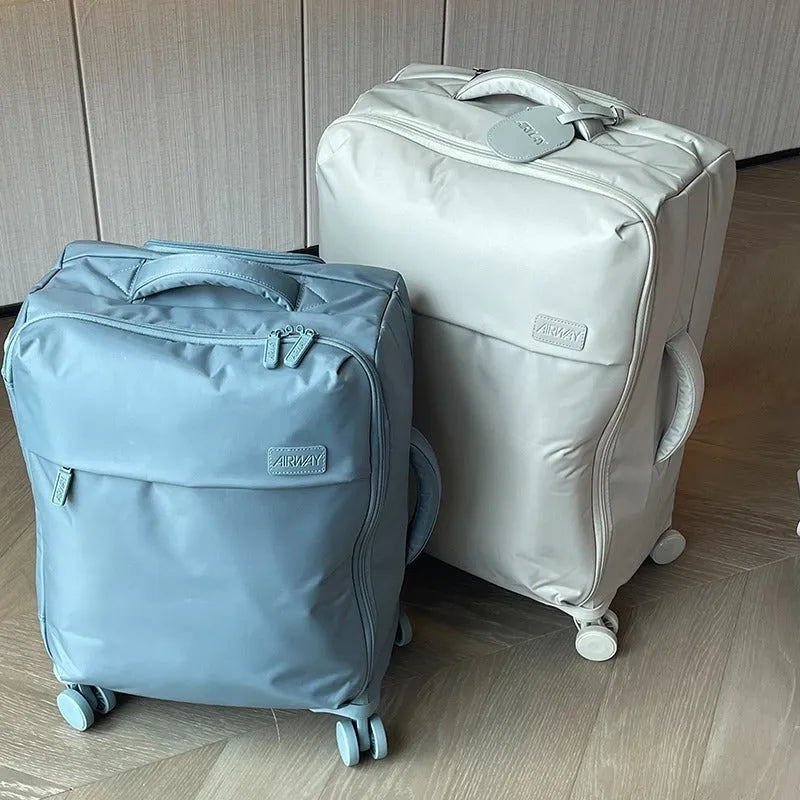 Ultra-light waterproof Oxford cloth suitcase in bluestone green with universal wheels.