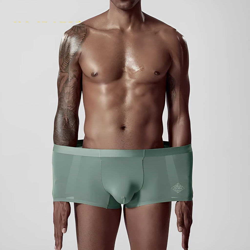 Seamless men's modal underwear in green colour showing mid-waist design and solid colour construction