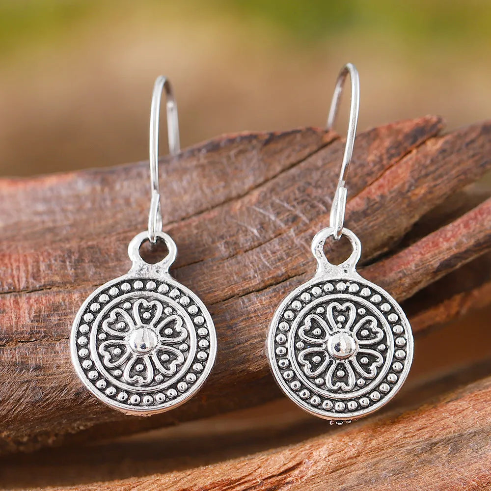 Bohemian style geometric earrings with distressed round print ethnic designs