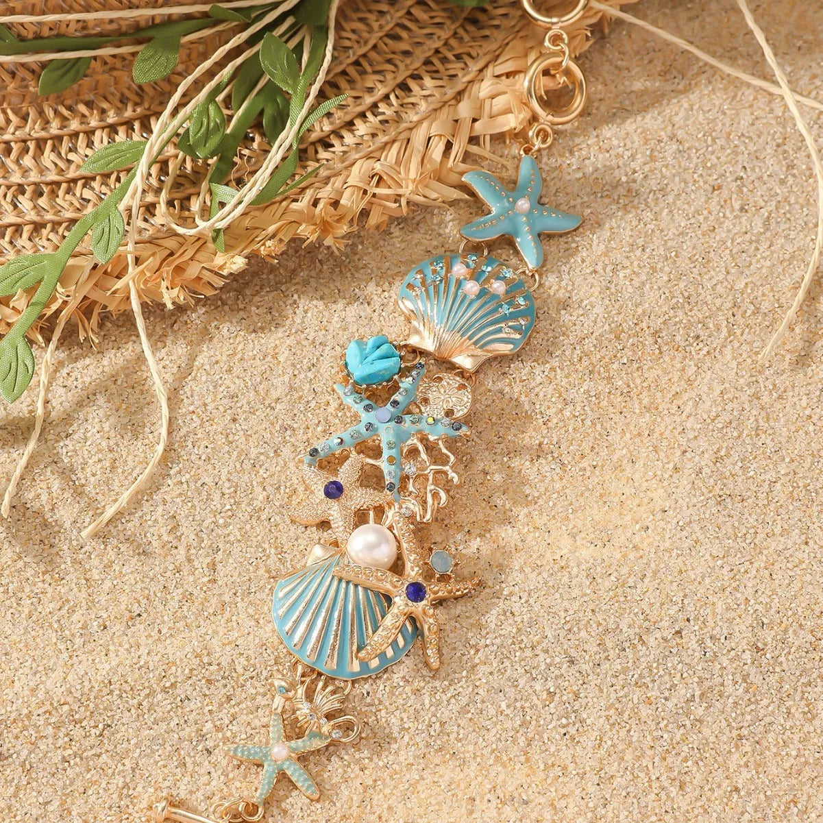 Alloy marine charm bracelet with shell, starfish, and anchor design in turquoise, red, or blue.
