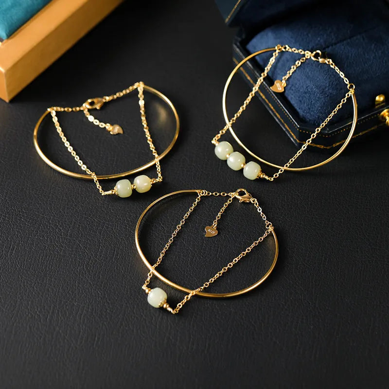 Hetian jade bracelet with gold inlay in single, double, and three bead versions on a wrist.