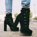 Women's suede high heel ankle boots with thick block heel in army green, showing round toe and belt buckle detail.