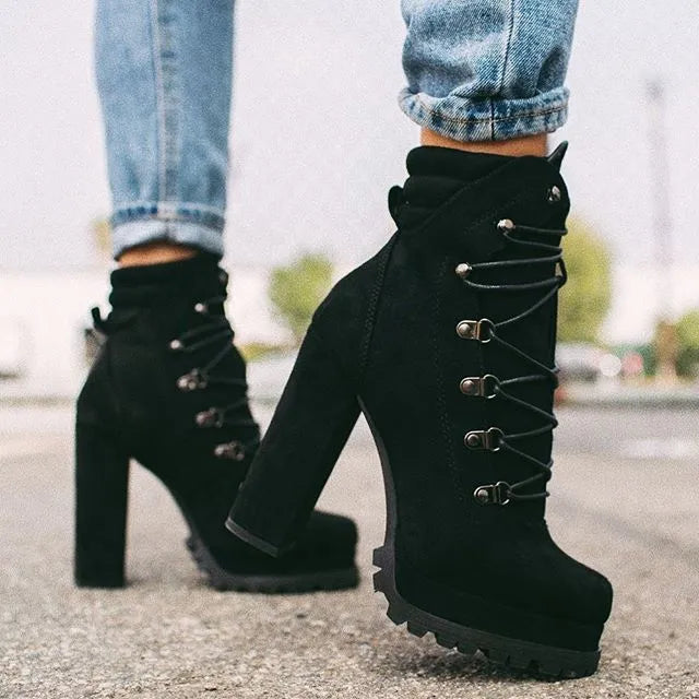 Women's suede high heel ankle boots with thick block heel in army green, showing round toe and belt buckle detail.