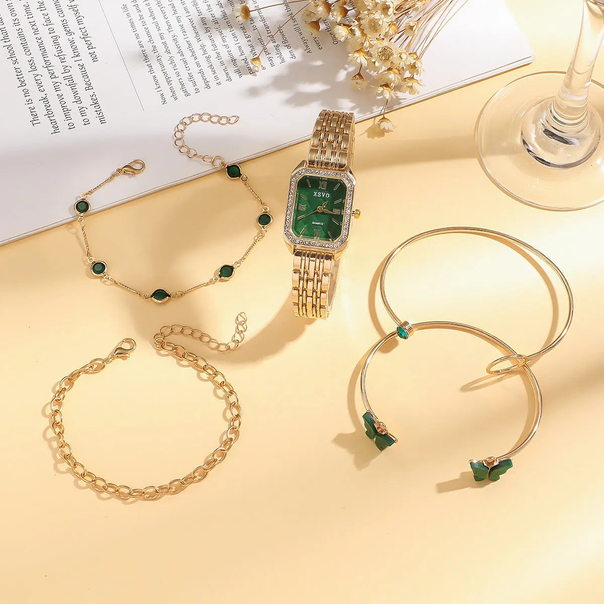 Gold green square steel watch with four matching alloy bracelets laid out as a complete gift set