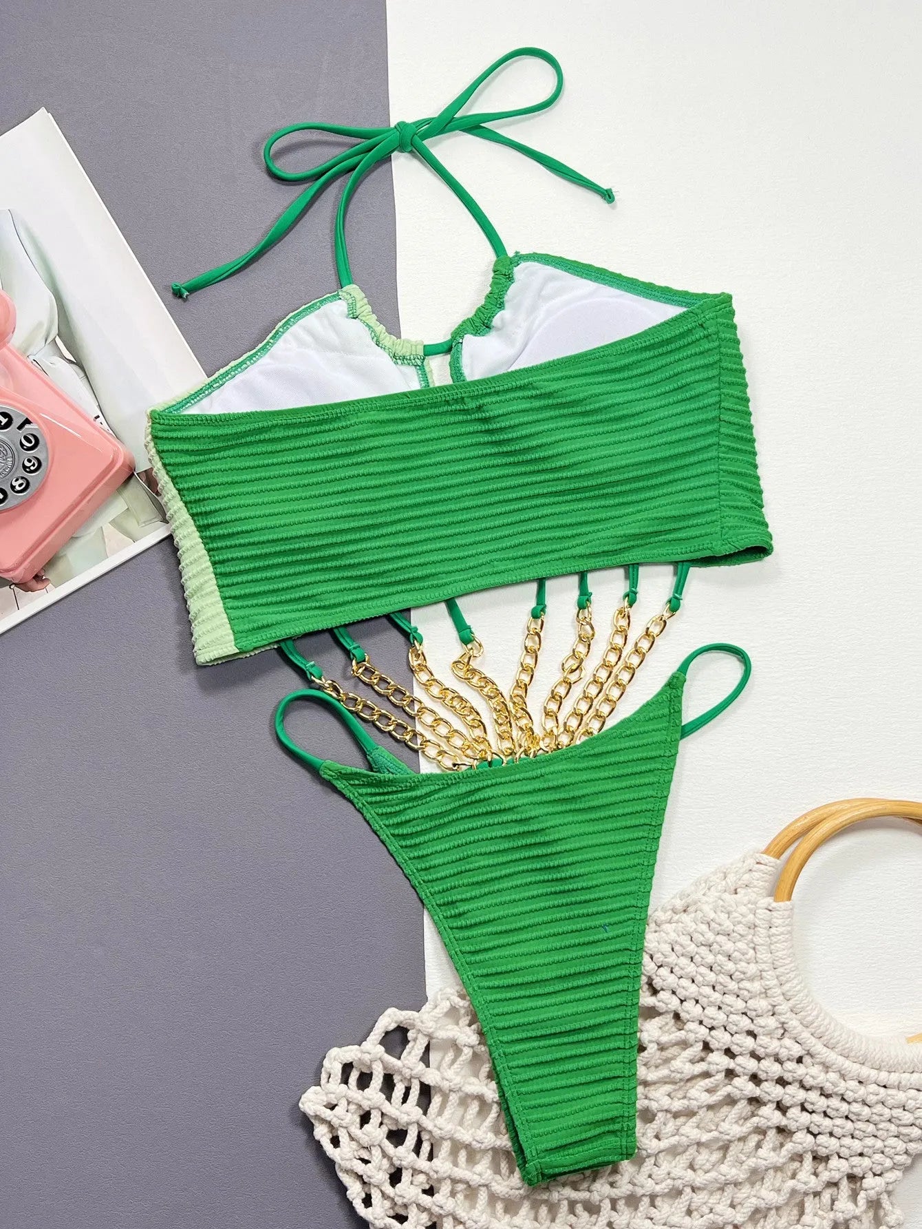 Green women's one-piece swimsuit with hollow design made from polyester fabric