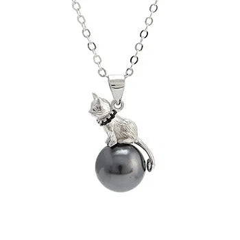 Close-up of a sterling silver cat pendant necklace on a clavicle-length chain, showing the electroplated finish.