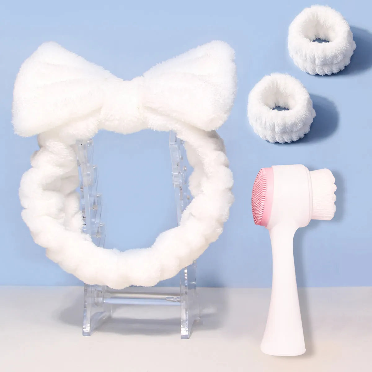 Facial brush set with coral fleece hair band and four nylon brush heads in purple grey white pink colours