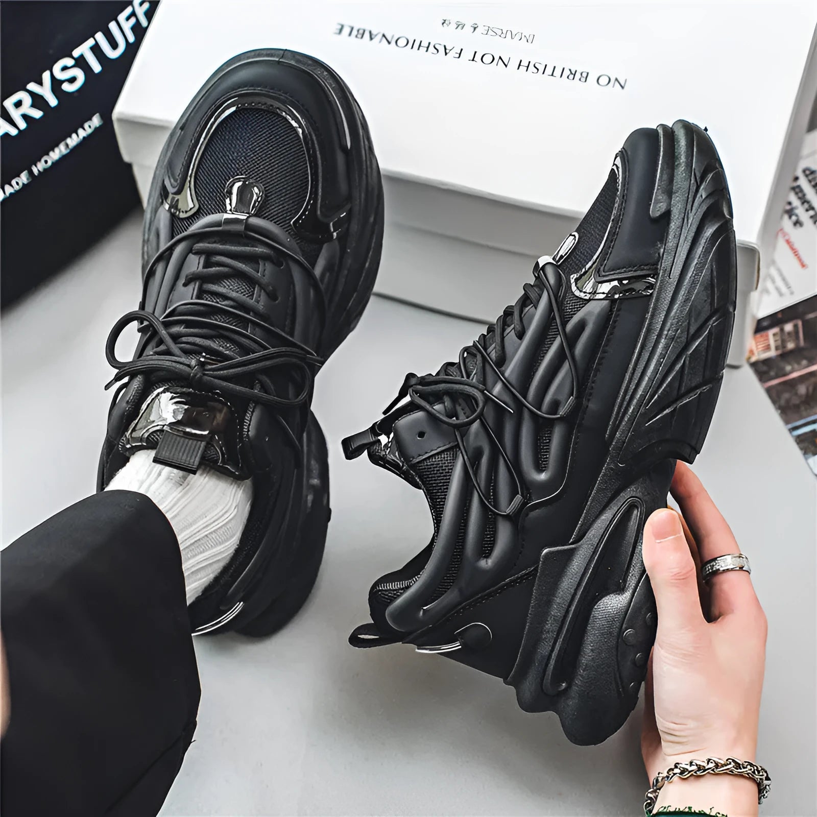 Men's beige and black sneakers with mesh upper, lace-up front, and rubber sole