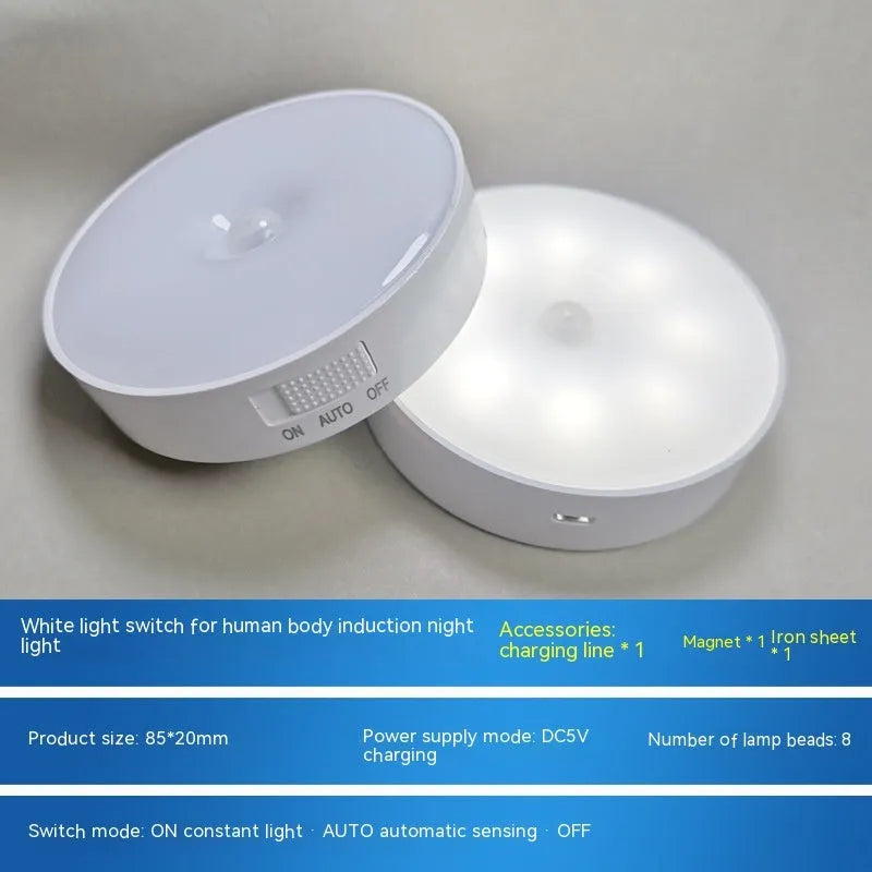 Small circular white motion sensing LED night light with USB charging cable and adhesive tape.