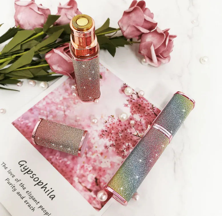 Lipstick shape electric eyebrow trimmer with gold plated head in Rainbow or Starry Sky colour, 2.5 x 2.5 x 12.5 cm.