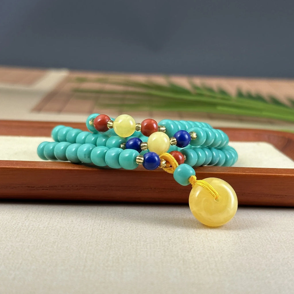 Turquoise stone mesh flower lucky pendant on an adjustable ball bead necklace chain.