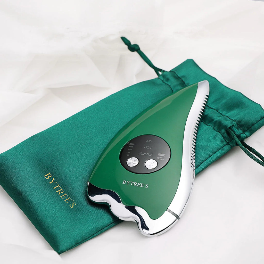 Green facial beauty instrument with vibration, hot and cold modes, and EMS micro current on a table
