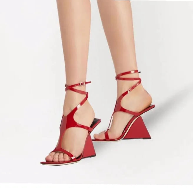 Women's black high heel sandals with 9.5cm wedge, square toe, and button fastening on a white background.