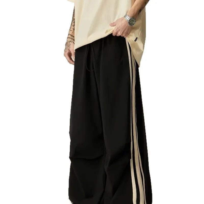 Black men's high waist wide leg climbing trousers on a hanger.